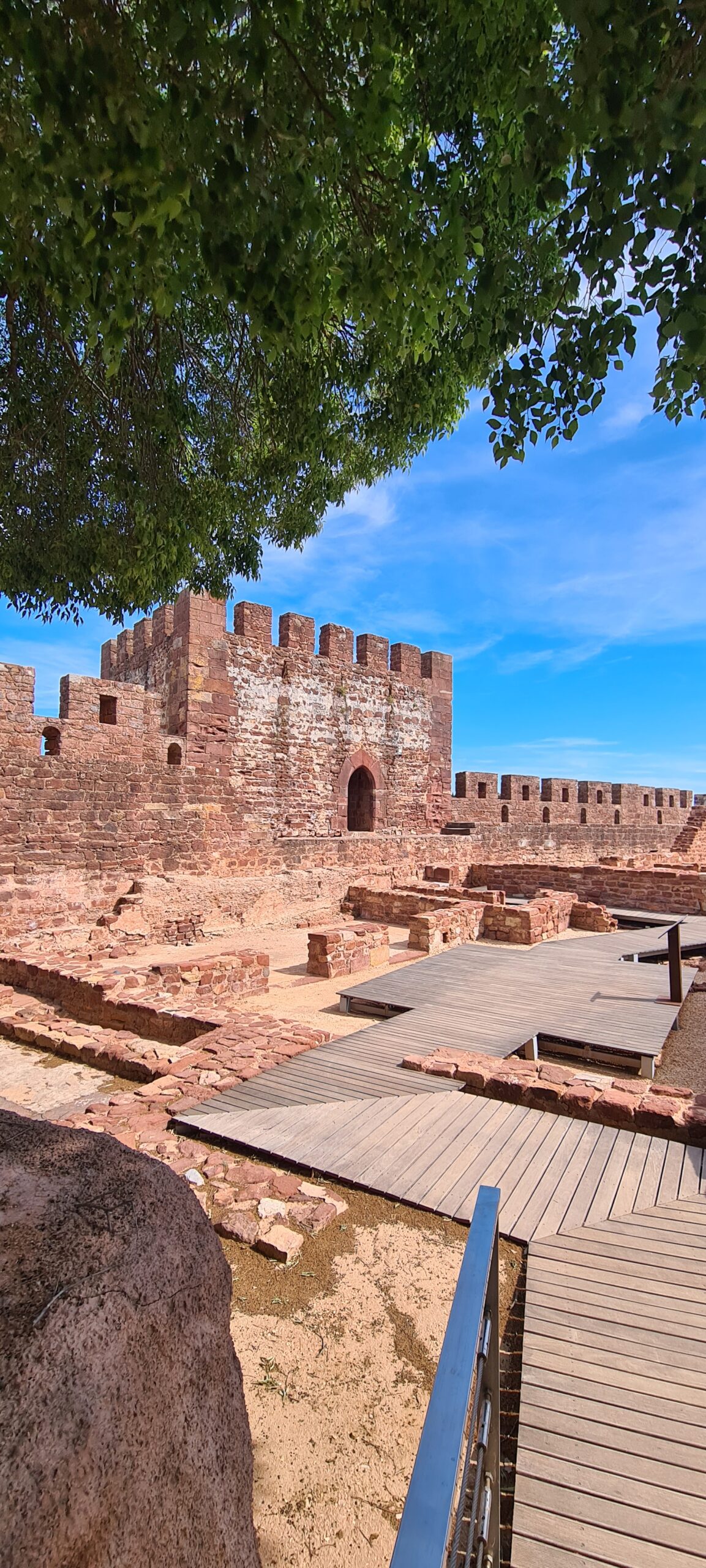 Red stone walls of the Castle of Silves in Portugal.