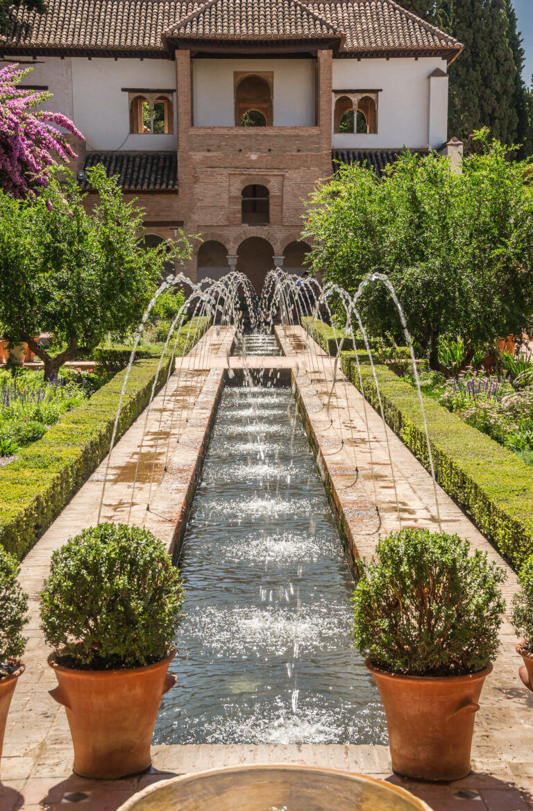 Patio de la Acequia in the Generalife gardens with water channels and planting beds.