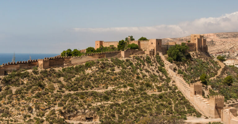 Outer walls and towers of the Alcazaba of Almeria under a clear sky.
